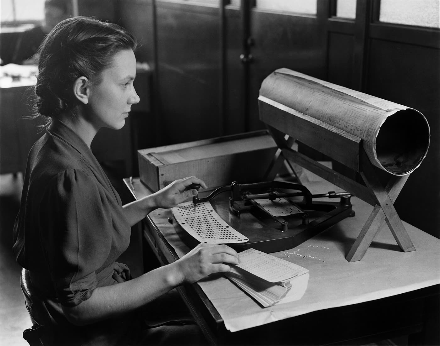A clerk in 1940 keying census cards by hand on a Hollerith punch