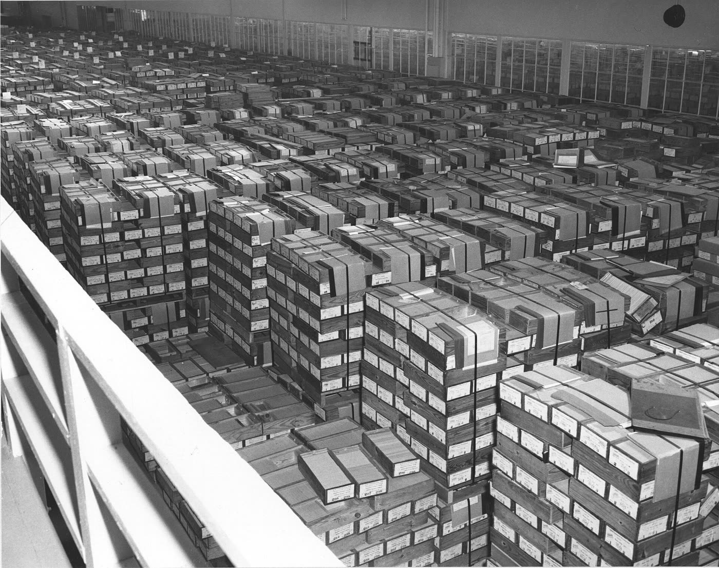 Rows of stacked boxes of punched cards filling a federal records warehouse in 1959