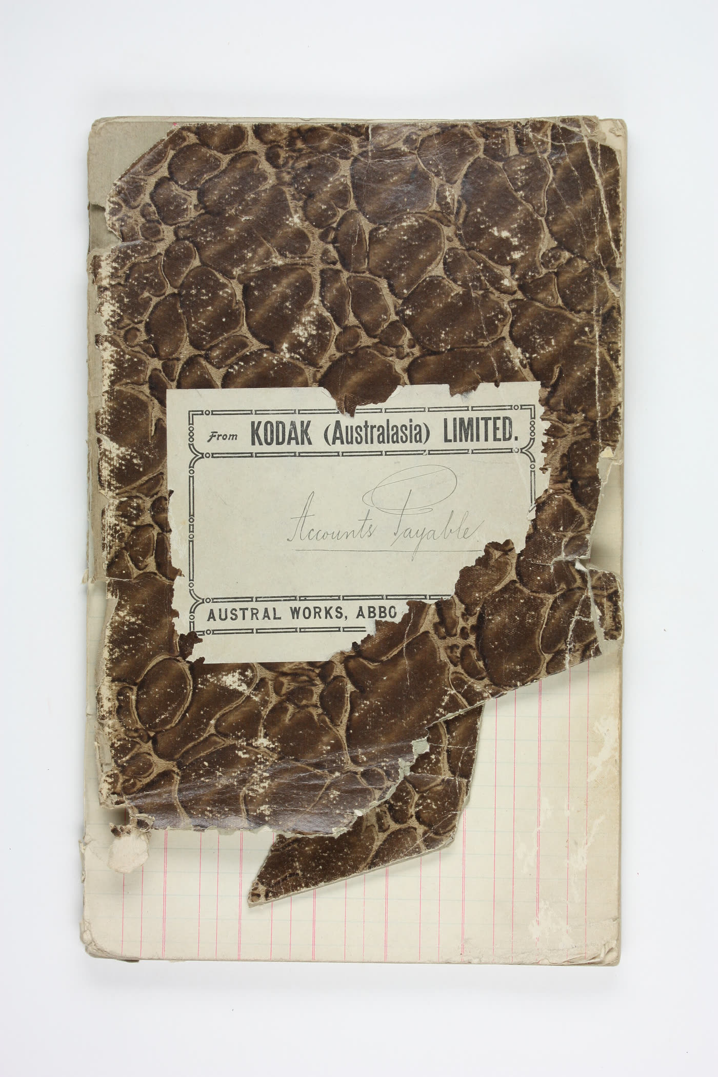 Worn marbled cover of a company accounts-payable ledger from the 1920s